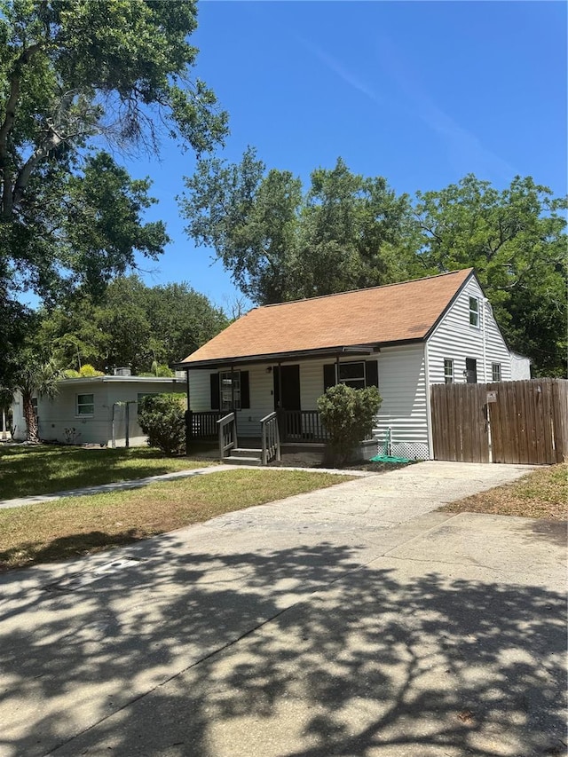 1675 13th Ave S, Saint Petersburg, FL 33712 - view of front of home with a porch, driveway, and roof with shingles