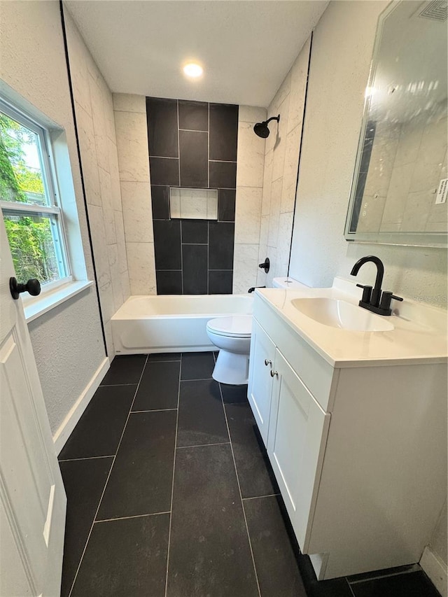 1675 13th Ave S, Saint Petersburg, FL 33712 - bathroom with tile patterned floors, toilet, vanity, bathtub / shower combination, and a textured wall
