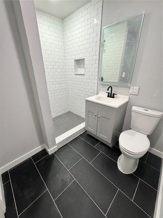 1675 13th Ave S, Saint Petersburg, FL 33712 - full bathroom with toilet, vanity, tiled shower, and tile patterned floors