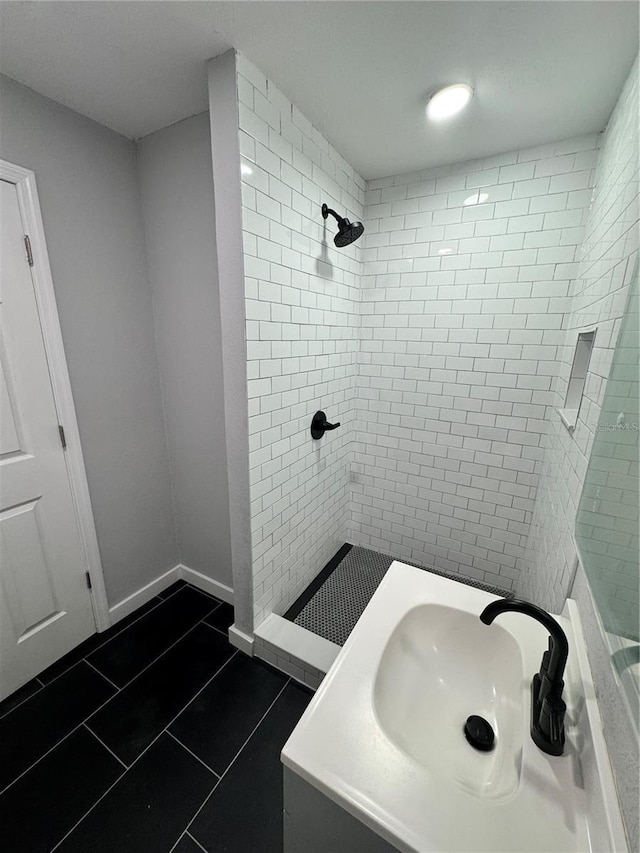 1675 13th Ave S, Saint Petersburg, FL 33712 - bathroom featuring tile patterned floors, a tile shower, and vanity