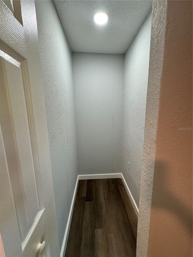 1675 13th Ave S, Saint Petersburg, FL 33712 - corridor featuring wood finished floors, a textured wall, and baseboards