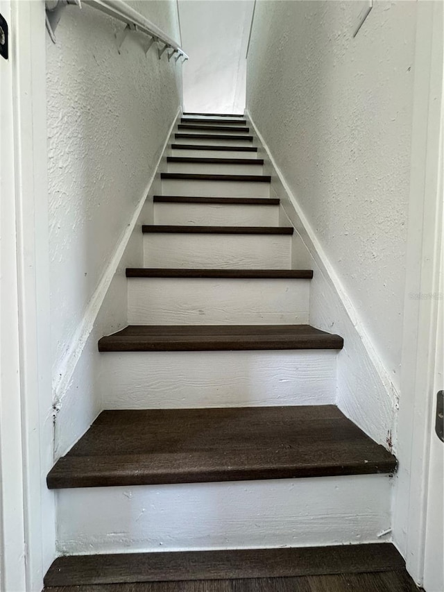 1675 13th Ave S, Saint Petersburg, FL 33712 - staircase featuring a textured wall and wood finished floors