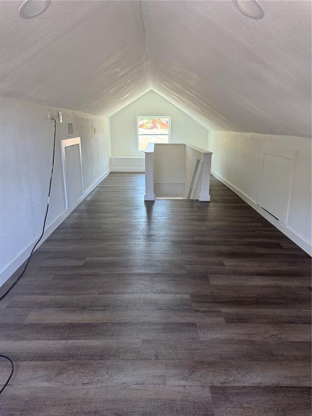 1675 13th Ave S, Saint Petersburg, FL 33712 - additional living space with vaulted ceiling, dark wood finished floors, and baseboards
