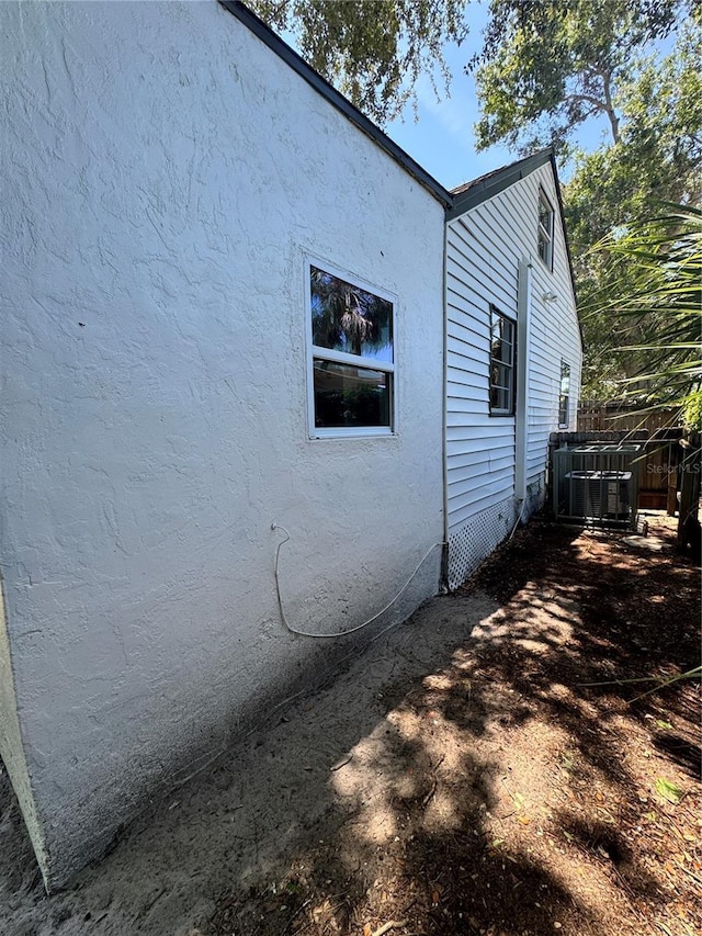 1675 13th Ave S, Saint Petersburg, FL 33712 - view of home's exterior with cooling unit and stucco siding