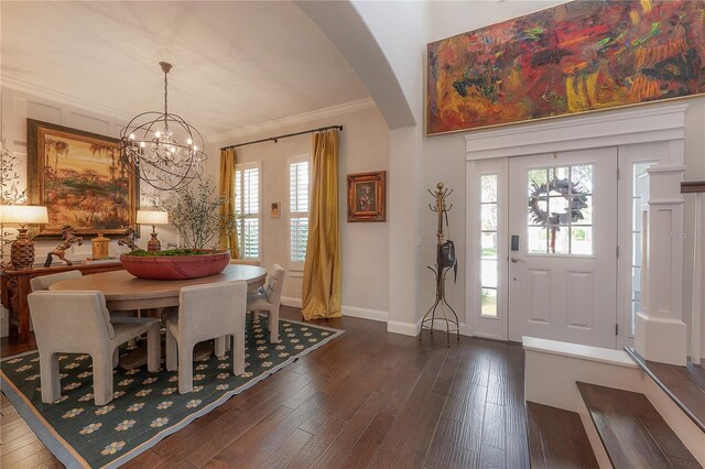8927 Key W Island Way, Riverview, FL 33578 - dining space with arched walkways, dark wood-type flooring, a chandelier, crown molding, and baseboards