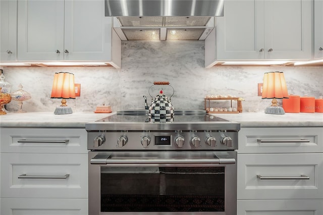 8927 Key W Island Way, Riverview, FL 33578 - kitchen with stainless steel range, custom range hood, backsplash, and white cabinets