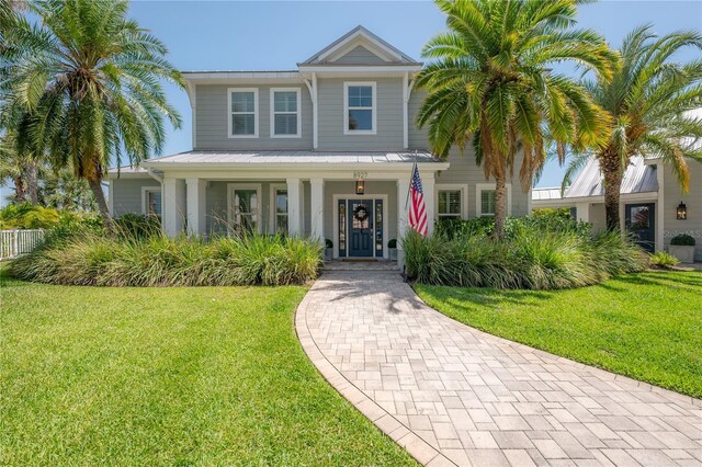 8927 Key W Island Way, Riverview, FL 33578 - view of front of home featuring a front yard, covered porch, metal roof, and a standing seam roof