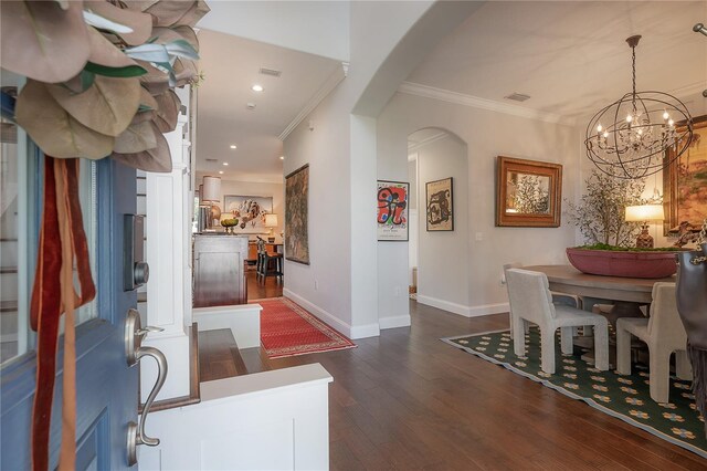 8927 Key W Island Way, Riverview, FL 33578 - dining space with a chandelier, baseboards, dark wood-style floors, arched walkways, and crown molding
