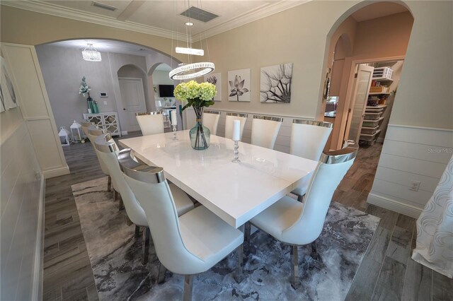 13103 Monach Isles Dr, Riverview, FL 33579 - dining space with arched walkways, dark wood-style flooring, crown molding, and a chandelier
