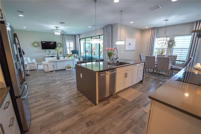 13103 Monach Isles Dr, Riverview, FL 33579 - kitchen with appliances with stainless steel finishes, a sink, a chandelier, open floor plan, and dark wood-style floors