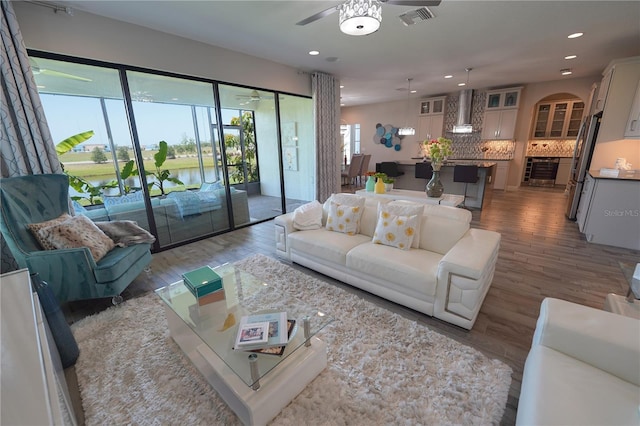 13103 Monach Isles Dr, Riverview, FL 33579 - living area featuring a ceiling fan, wood finished floors, recessed lighting, and a water view