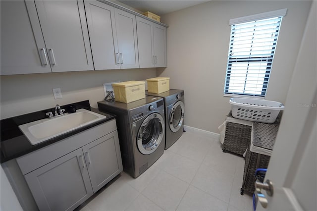 13103 Monach Isles Dr, Riverview, FL 33579 - washroom featuring washer and clothes dryer, cabinet space, baseboards, and light tile patterned floors