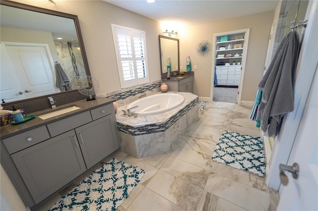 13103 Monach Isles Dr, Riverview, FL 33579 - full bathroom featuring a bath, a shower stall, and two vanities