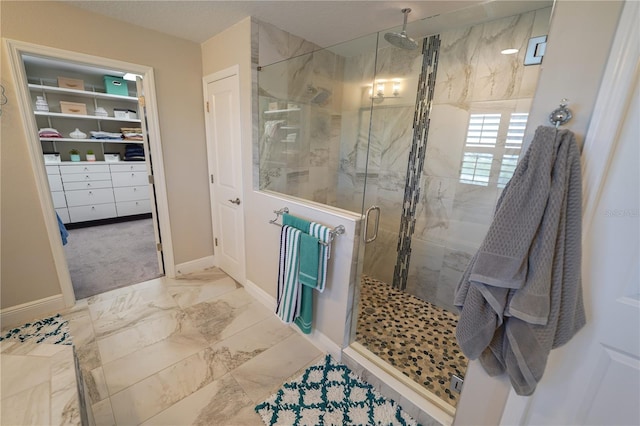 13103 Monach Isles Dr, Riverview, FL 33579 - full bath with a stall shower, baseboards, marble look tiles, and a spacious closet