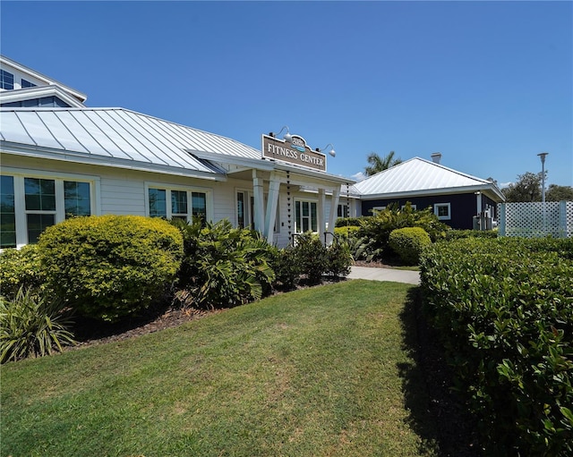 13103 Monach Isles Dr, Riverview, FL 33579 - view of front facade with a standing seam roof, metal roof, and a front yard