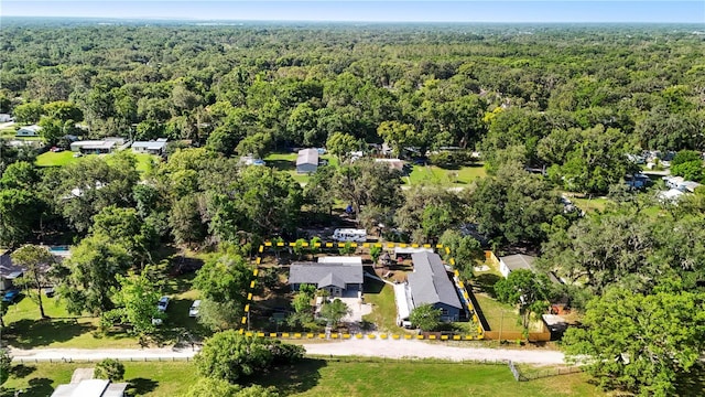 aerial overview of property's location with a heavily wooded area and property boundaries highlighted