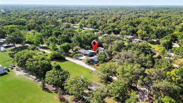 view of property location with a heavily wooded area