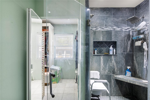 full bathroom with a shower stall, tile patterned floors, and toilet