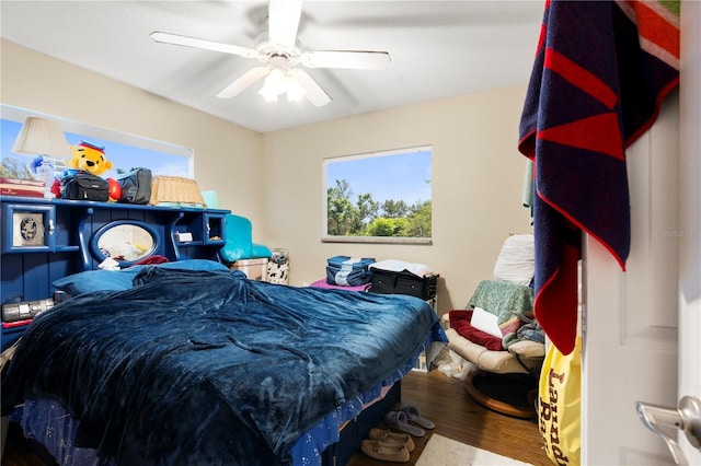 bedroom with wood finished floors and a ceiling fan