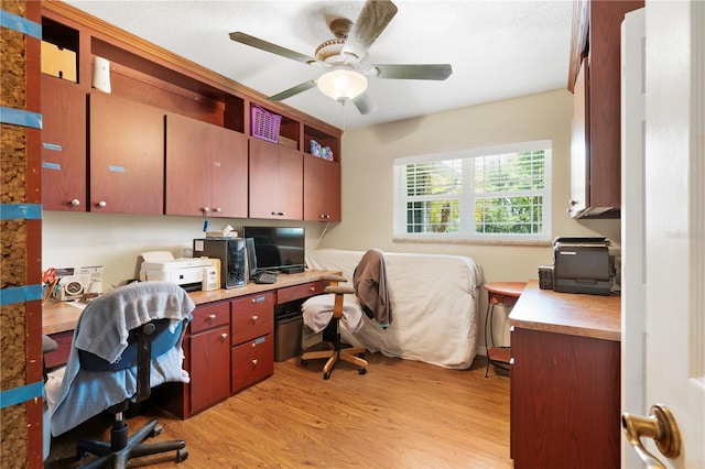 office with light wood-style flooring and a ceiling fan