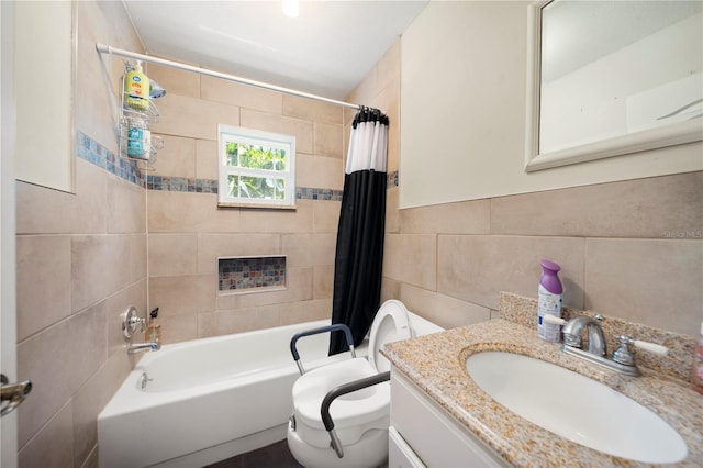 full bath with tile walls, shower / bath combination with curtain, toilet, and vanity