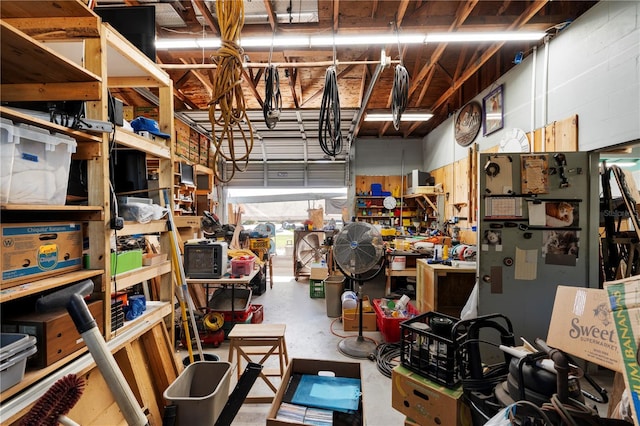 garage featuring a workshop area and freestanding refrigerator