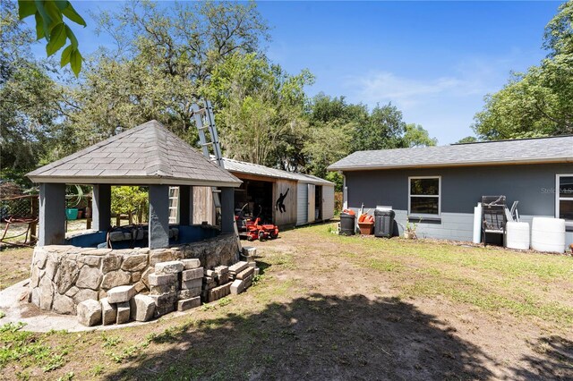 view of yard featuring a gazebo, an outbuilding, and a storage unit