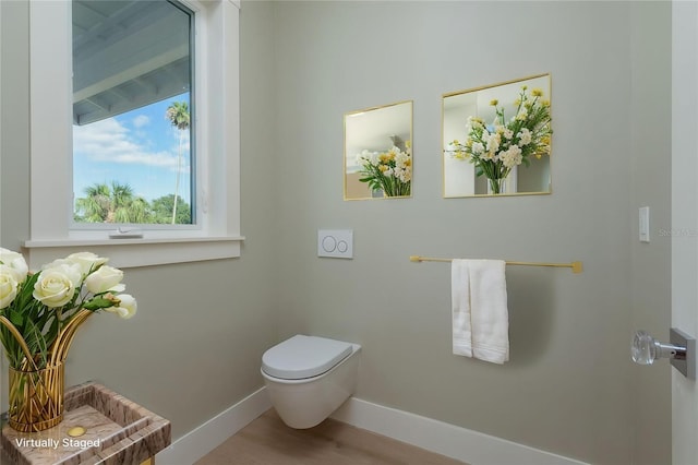 3752 Arkansas Ave NE, Saint Petersburg, FL 33703 - bathroom with baseboards, toilet, and wood finished floors