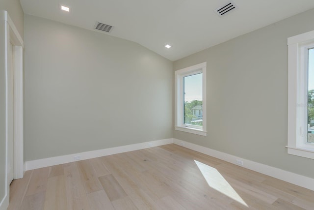 3752 Arkansas Ave NE, Saint Petersburg, FL 33703 - spare room featuring wood finished floors, vaulted ceiling, and baseboards