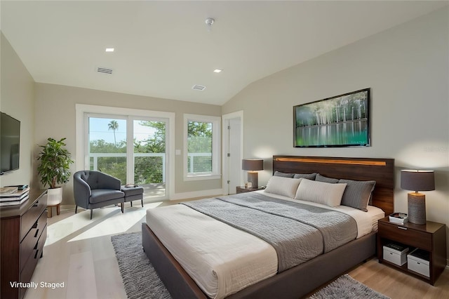 3752 Arkansas Ave NE, Saint Petersburg, FL 33703 - bedroom with light wood-style floors, vaulted ceiling, access to exterior, and recessed lighting