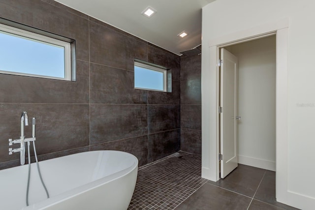 3752 Arkansas Ave NE, Saint Petersburg, FL 33703 - bathroom with tile patterned flooring, tiled shower, and a soaking tub