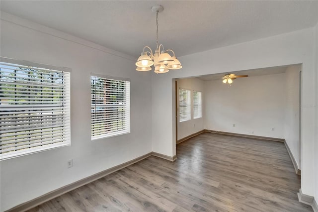 1920 E Chelsea St, Tampa, FL 33610 - empty room featuring a chandelier, wood finished floors, baseboards, and ceiling fan