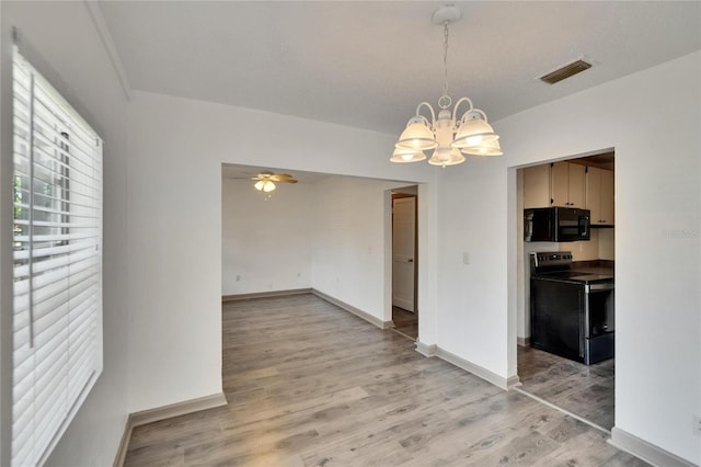 1920 E Chelsea St, Tampa, FL 33610 - unfurnished dining area featuring a chandelier, light wood-style flooring, baseboards, and ceiling fan