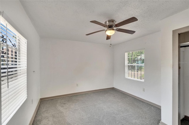1920 E Chelsea St, Tampa, FL 33610 - unfurnished bedroom with carpet flooring, a textured ceiling, baseboards, and ceiling fan