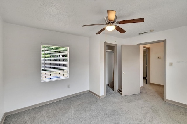 1920 E Chelsea St, Tampa, FL 33610 - unfurnished bedroom with light carpet, a textured ceiling, baseboards, a closet, and ceiling fan