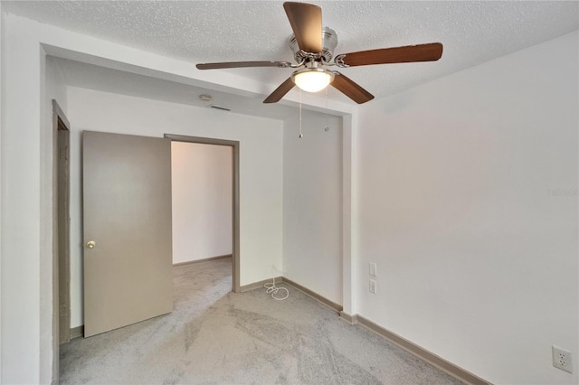 1920 E Chelsea St, Tampa, FL 33610 - unfurnished bedroom with light carpet, a textured ceiling, baseboards, and ceiling fan