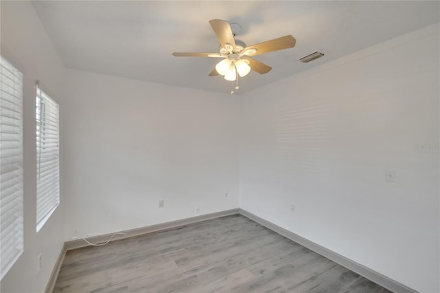1920 E Chelsea St, Tampa, FL 33610 - spare room with a ceiling fan, light wood-style floors, and baseboards