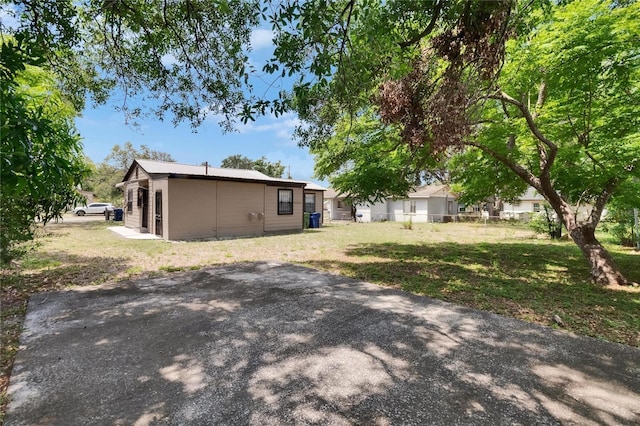 1920 E Chelsea St, Tampa, FL 33610 - rear view of house with a yard