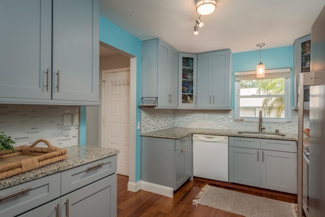 1065 Tartan Dr Unit C, Palm Harbor, FL 34684 - kitchen with dishwasher, a sink, dark wood-type flooring, decorative backsplash, and glass insert cabinets