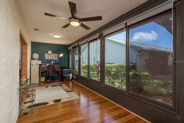 1065 Tartan Dr Unit C, Palm Harbor, FL 34684 - office space with wood finished floors, healthy amount of natural light, a textured wall, ceiling fan, and a textured ceiling