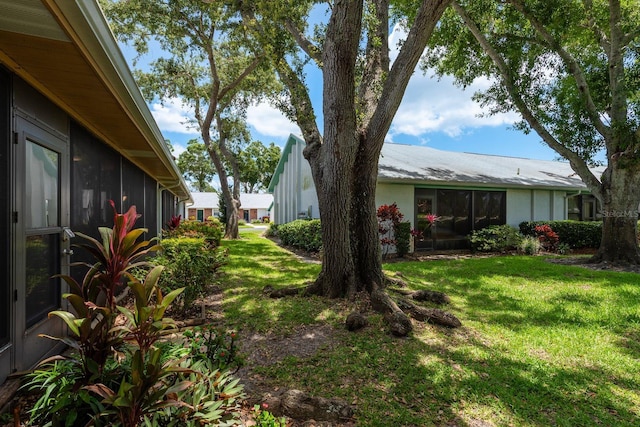 1065 Tartan Dr Unit C, Palm Harbor, FL 34684 - view of green lawn with a sunroom