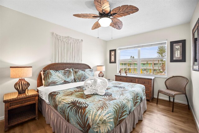 600 71st Ave Unit 18, St Pete Beach, FL 33706 - bedroom featuring wood finished floors, baseboards, and a ceiling fan