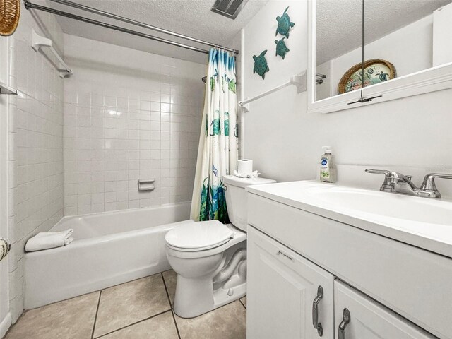 600 71st Ave Unit 18, St Pete Beach, FL 33706 - full bathroom with vanity, shower / bath combination with curtain, tile patterned floors, toilet, and a textured ceiling