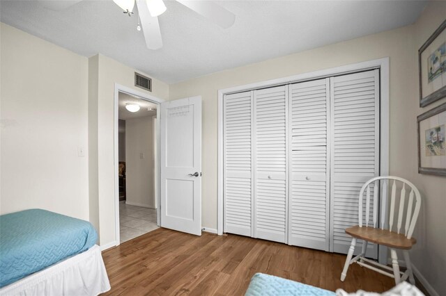 600 71st Ave Unit 18, St Pete Beach, FL 33706 - bedroom featuring wood finished floors, a closet, baseboards, and ceiling fan
