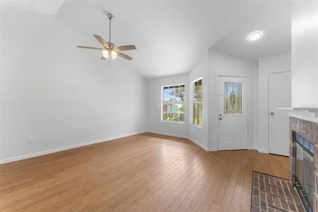 2313 Palm Ave, Seffner, FL 33584 - unfurnished living room featuring vaulted ceiling, a fireplace, light wood-type flooring, a ceiling fan, and baseboards