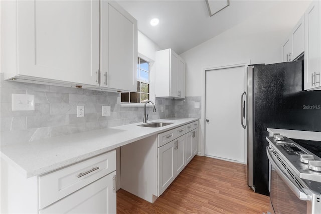 2313 Palm Ave, Seffner, FL 33584 - kitchen featuring a sink, electric stove, lofted ceiling, and white cabinets
