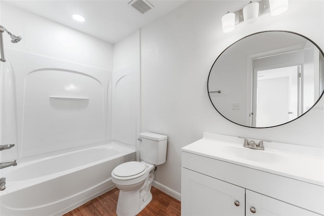 2313 Palm Ave, Seffner, FL 33584 - bathroom featuring wood finished floors, toilet, shower / washtub combination, baseboards, and vanity