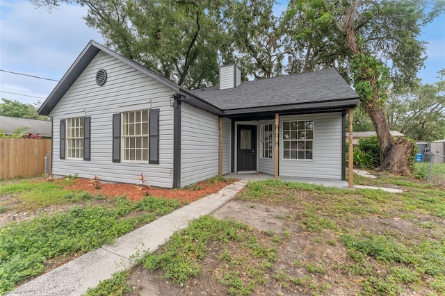 2313 Palm Ave, Seffner, FL 33584 - view of front of home featuring fence, a chimney, and a shingled roof