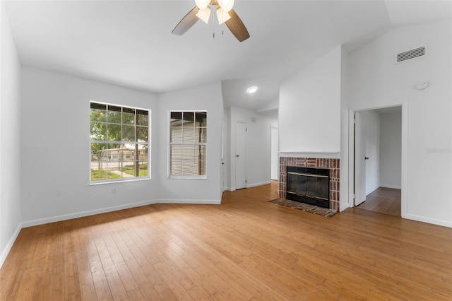 2313 Palm Ave, Seffner, FL 33584 - unfurnished living room with lofted ceiling, ceiling fan, wood finished floors, and a brick fireplace