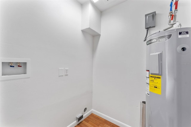 2313 Palm Ave, Seffner, FL 33584 - laundry area featuring electric water heater, hookup for an electric dryer, hookup for a washing machine, and wood finished floors
